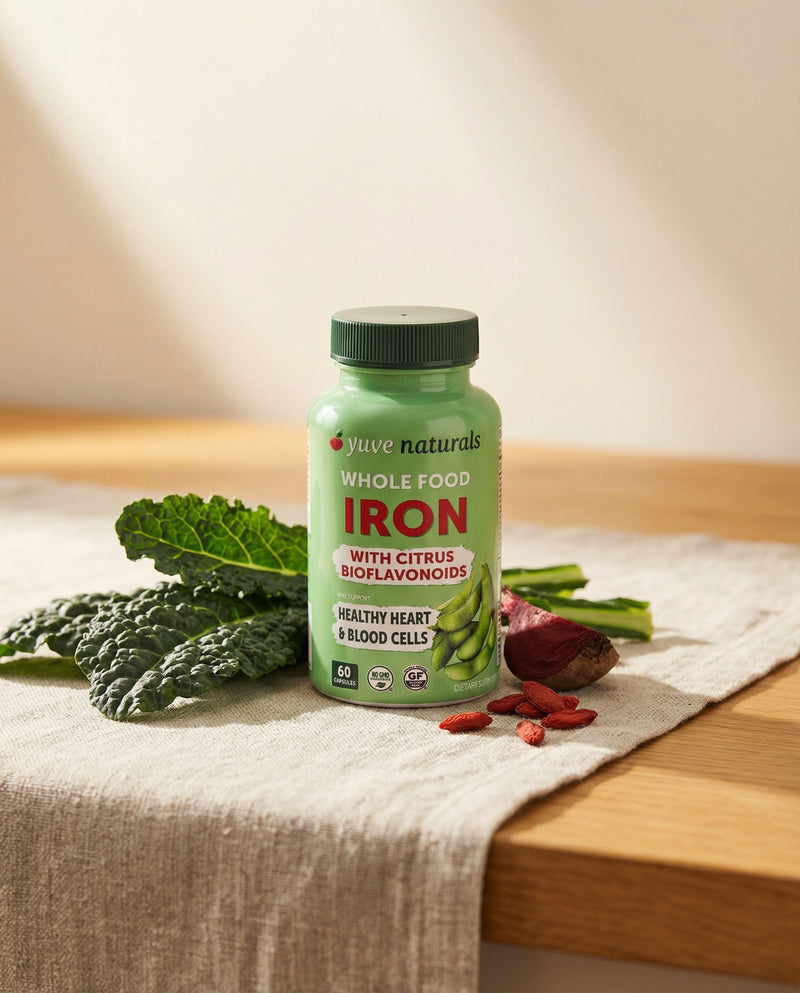 Yuve Whole Food Iron on a linen kitchen counter with dark leafy greens